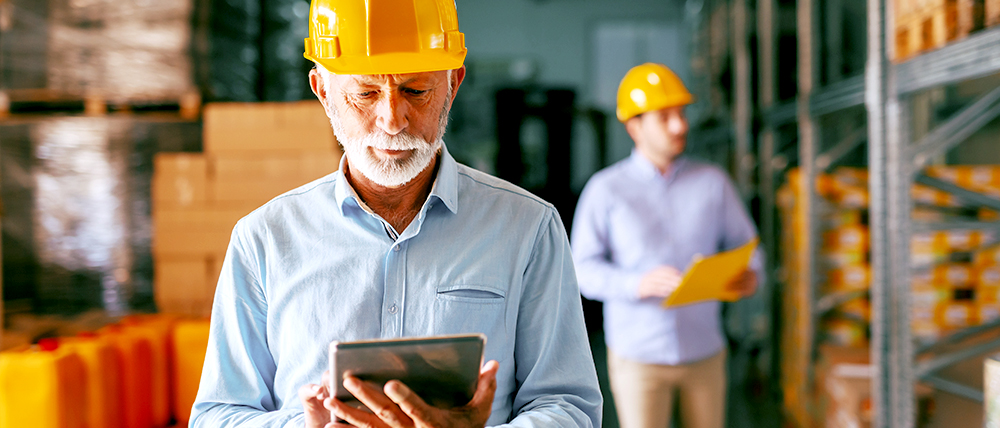 Men wearing hard hats in warehouse setting